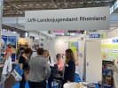 Man sieht den Stand des LVR-Landesjugendamts auf der didacta. Eine Gruppe von Menschen unterhält sich. Im Hintergrund stehen Stellwände und Aufsteller.